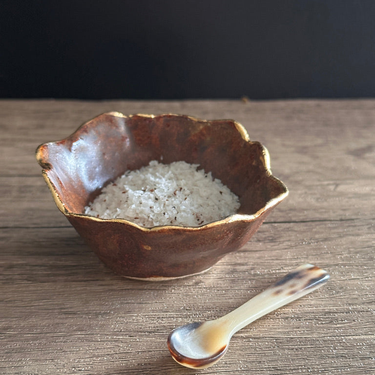 Chestnut Ceramic small pot with gold rim with sea salt and a horn spoon 