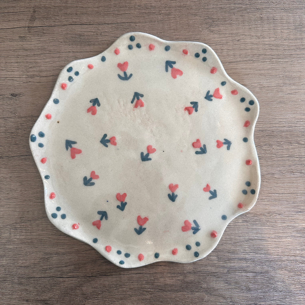 Decorative handmade ceramic plate with floral heart design in pink and green