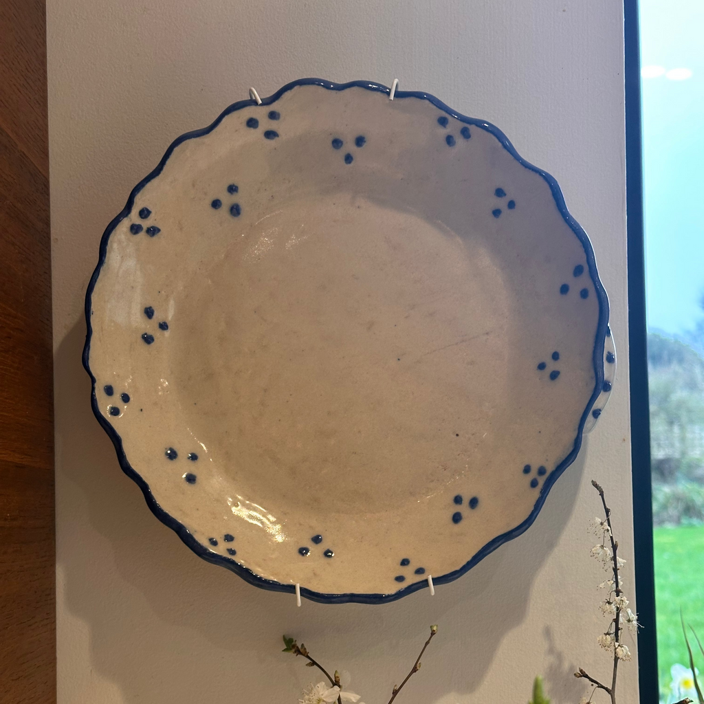 Handmade ceramic platter with blue decorative edge 
