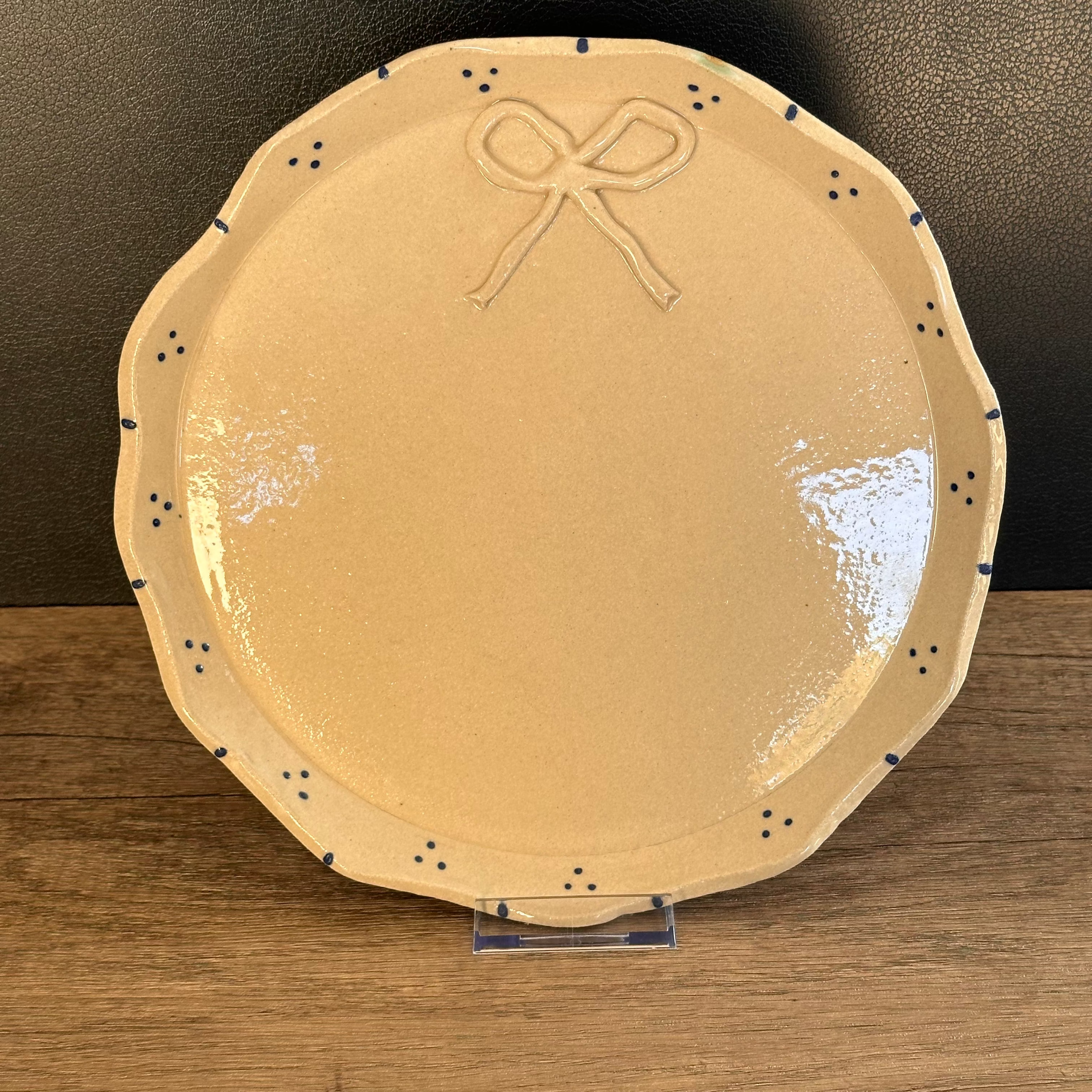 Handmade ceramic plate with ribbon detail and blue dots
