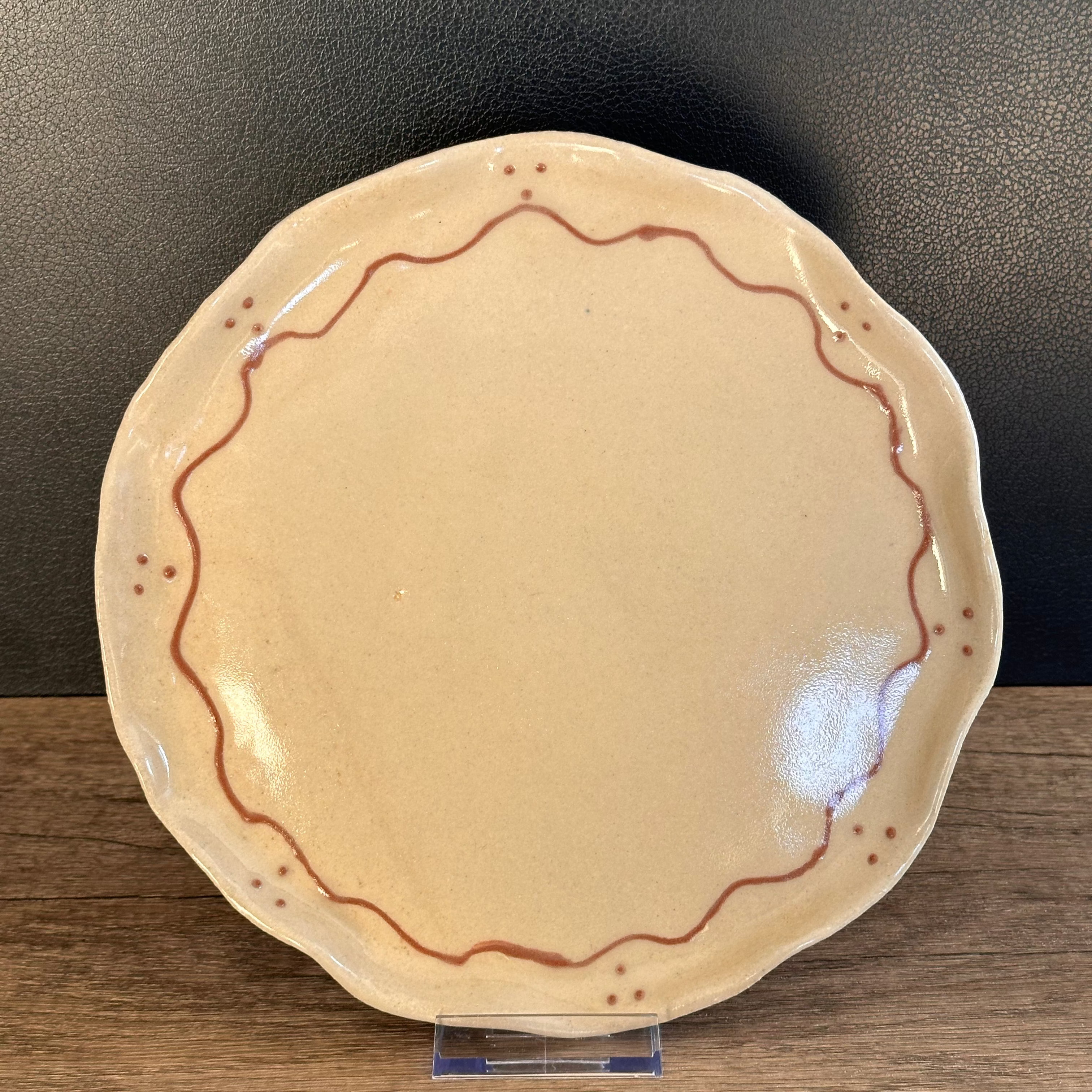 Cream ceramic plate decorated with terracotta coloured slip, handmade, functional and decorative