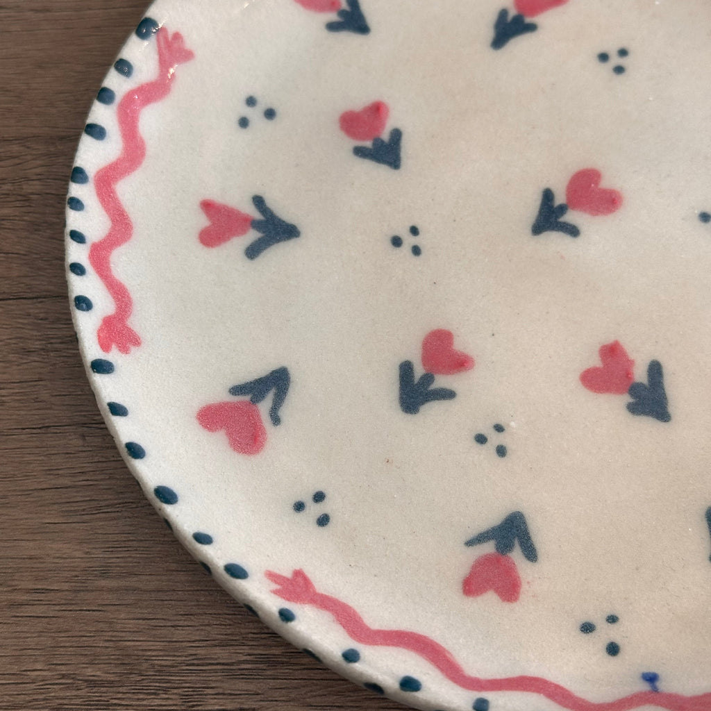 Handmade ceramic plate by Natalie Haynes with floral hearts  pattern in pink and green