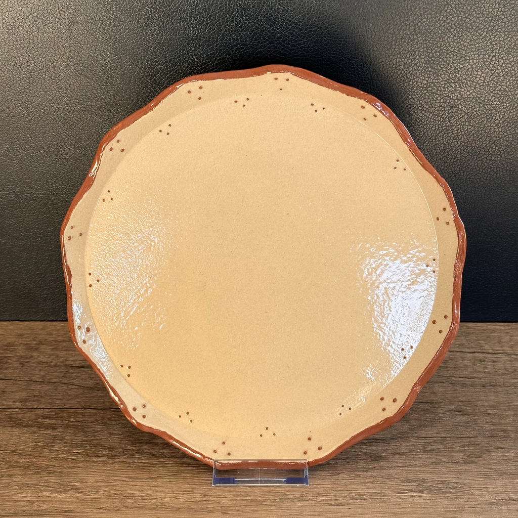 Ceramic plate hand decorated with terracotta coloured slip dots