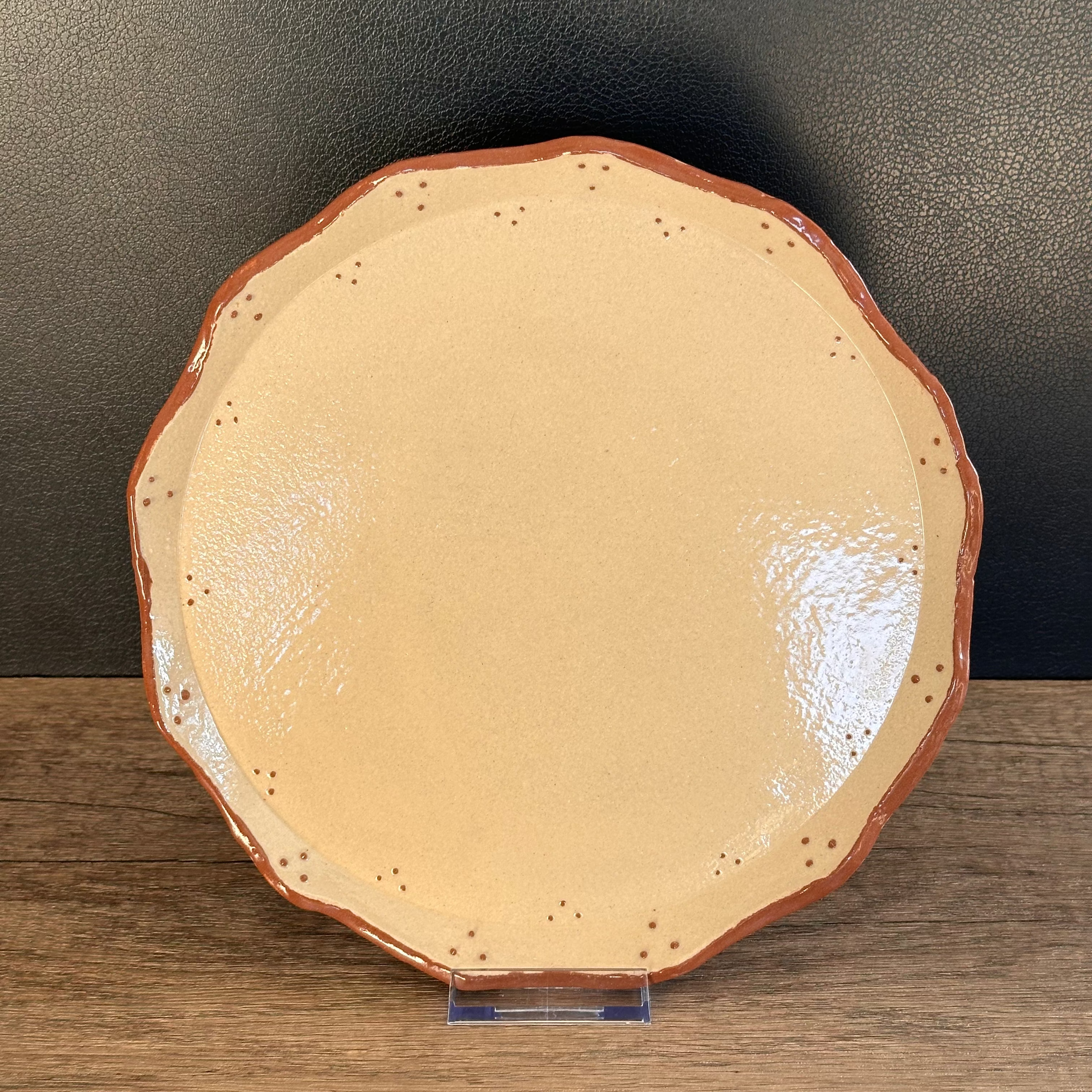 Ceramic plate hand decorated with terracotta coloured slip dots